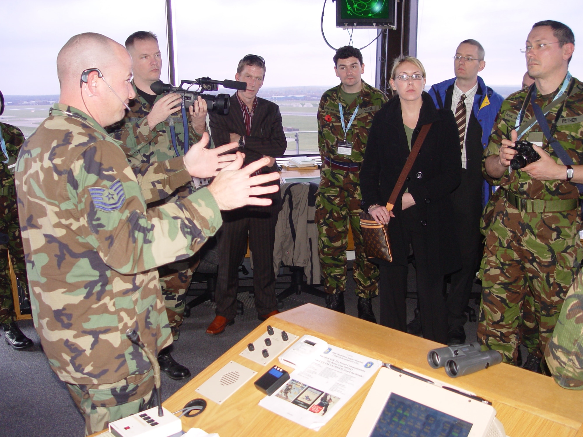 Tech. Sgt. William Muir, 100th Air Refueling Wing air traffic controller, briefs members of the 7644 (VR) Squadron, Royal Auxiliary Air Force on ATC tower operations at RAF Mildenhall Saturday during a unit visit. (U.S. Air Force photo by Master Sgt. Dennis Brewer)