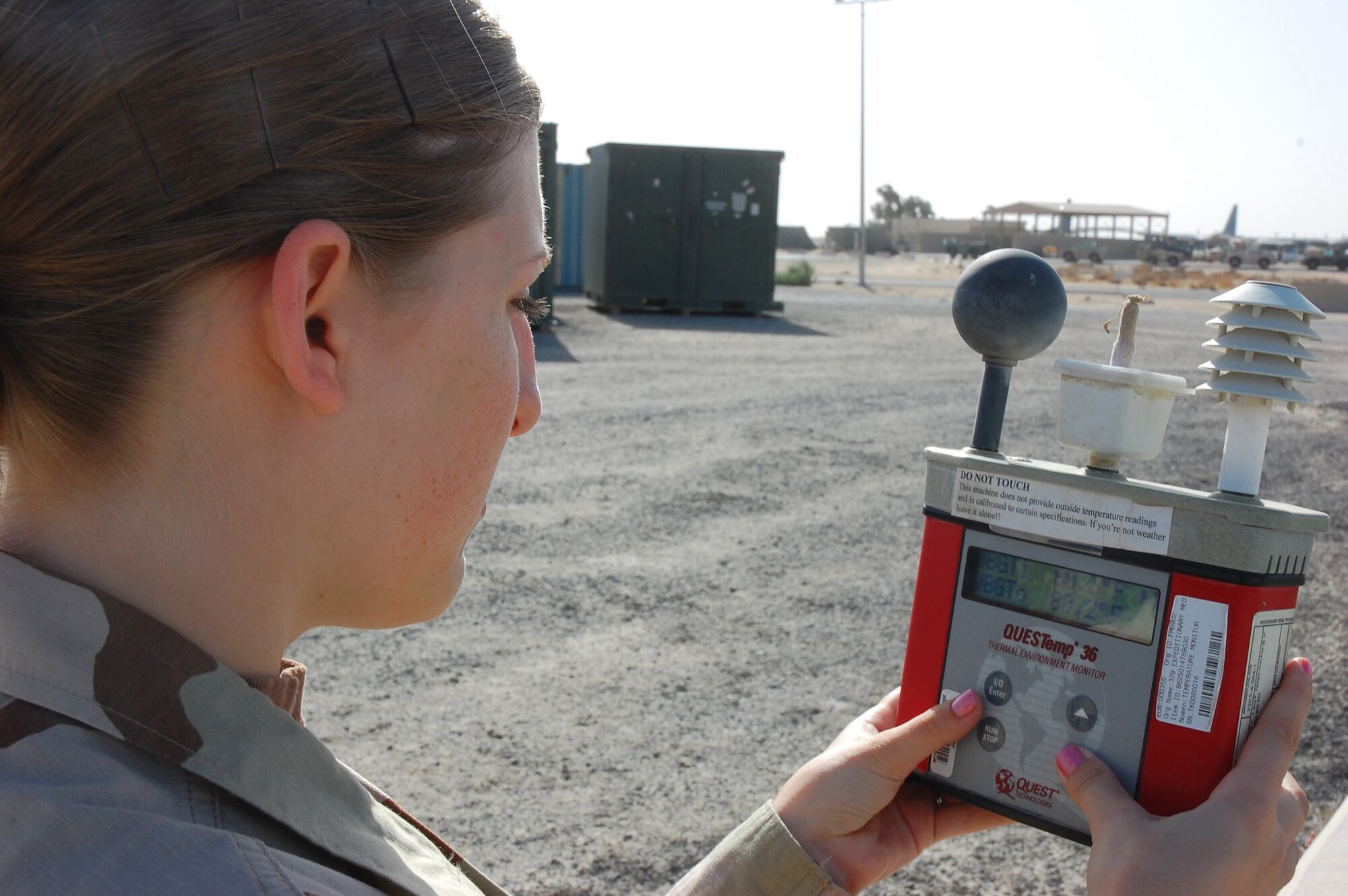 SOUTHWEST ASIA -- Staff Sgt. Tricia Williamson, 386th Expeditionary Operations Group weather forecaster, conducts a wet bulb globe temperature test, which calculates the heat stress level for the base, Nov. 2 here.  Sergeant Williamson is deployed from Royal Air Force Mildenhall, England.  (U.S. Air Force photo by Staff Sgt. Tia Schroeder)
