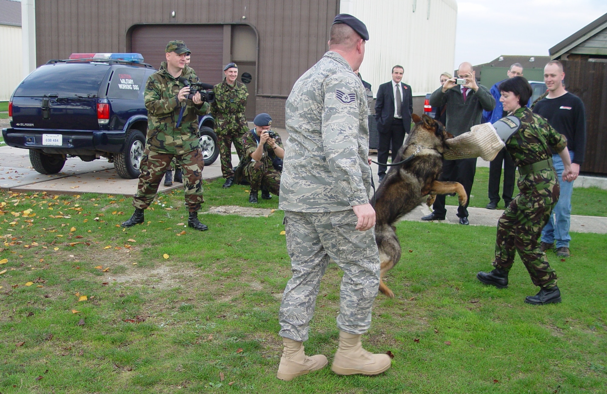 Staff Sgt. Ryan Purvis’ ‘War,’ a K-9 military working dog, provides a once-in-a-lifetime training experience for Officer Cadet Lesley Woods, 7644 (VR) Squadron, Royal Auxiliary Air Force, Saturday. (U.S. Air Force photo by Master Sgt. Dennis Brewer)