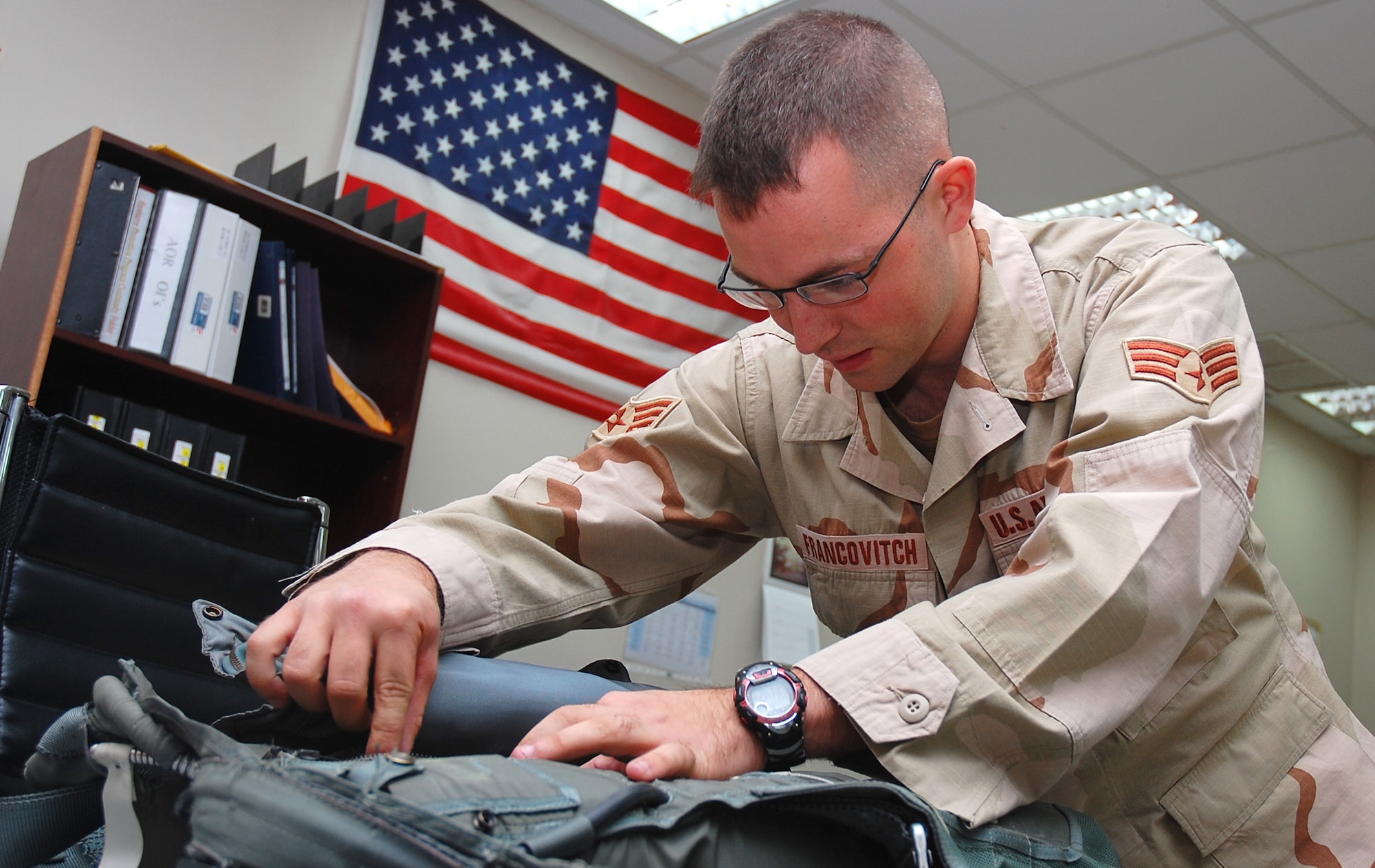 SOUTHWEST ASIA -- Senior Airman Joshua Francovitch, 386th Expeditionary Operations Group aircrew life support technician, performs a routine inspection on a back-automatic parachute Nov. 2 here.  Airman Francovitch is deployed from Yakota AB, Japan.  (U.S. Air Force photo by Staff Sgt. Tia Schroeder)