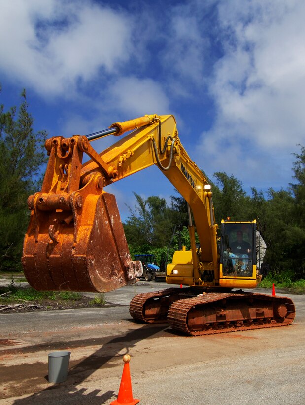 Chuck Watson, co-founder and chairman of Eagle Energy Partners, Houston, Texas, tries to grab a baseball with a backhoe during a civil engineering orientation as part of the 74th Joint Civilian Orientation Conference here on Andersen Air Force Base, Guam, Nov. 6, 2007. 