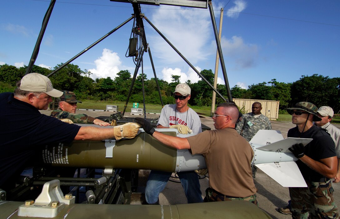 Members of the 36th Munitions Squadron and the 74th Joint Civilian Orientation Conference put together a GBU-50 bomb as part of an orientation of munitions on Andersen Air Force Base, Guam, Nov. 6, 2007.  