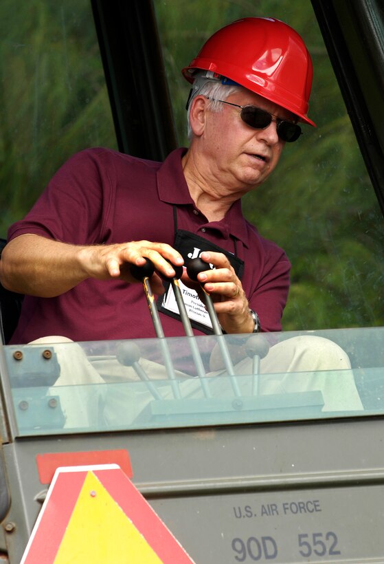 Timothy John Kriewall, president of Wisconsin Lutheran College, Milwaukee, Wisc., tries to grab a baseball with a backhoe during a civil engineering orientation as part of the 74th Joint Civilian Orientation Conference here on Andersen Air Force Base, Guam, Nov. 6, 2007. 