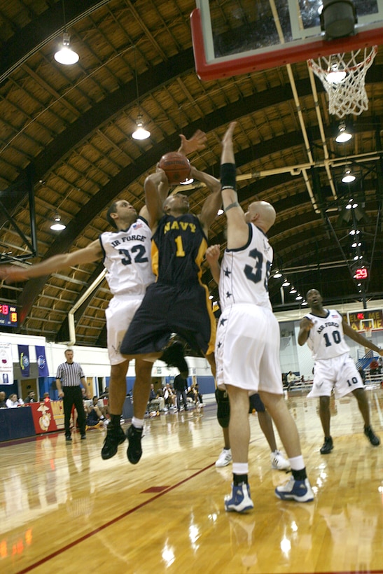 MARINE CORPS AIR STATION CHERRY POINT, N.C. (November 9, 2007) – All-Navy forward Seaman Devon Wilson lays up the ball past All-Air Force Defenders center Tech Sgt. William Griffith (Number 35) and guard Airman 1st Class Johnny Hernandez (Number 32) during game 10 of the Armed Forces Men's Basketball Championship. Wilson is stationed at Strike Force Training Command  Atlantic, Norfolk, Va. Griffith is an Olney, Md. native and is stationed at Eielson Air Force Base, Ak. Hernandez is a Chester, Va. native and is stationed at Seymour Johnson Air Force Base, N.C. The Armed Forces Men’s Basketball Championships were held at Marine Corps Air Station Cherry Point, N.C. Nov. 3-8. The All-Air Force team took home the Gold Medal and was undefeated with a final record of 6-0. The All-Marine team took home the Silver Medal, with a final record of 3-3. The All-Army team came in third place and All-Navy came in fourth. (U.S. Marine Corps photo by Cpl. Steven Cushman) (Released).