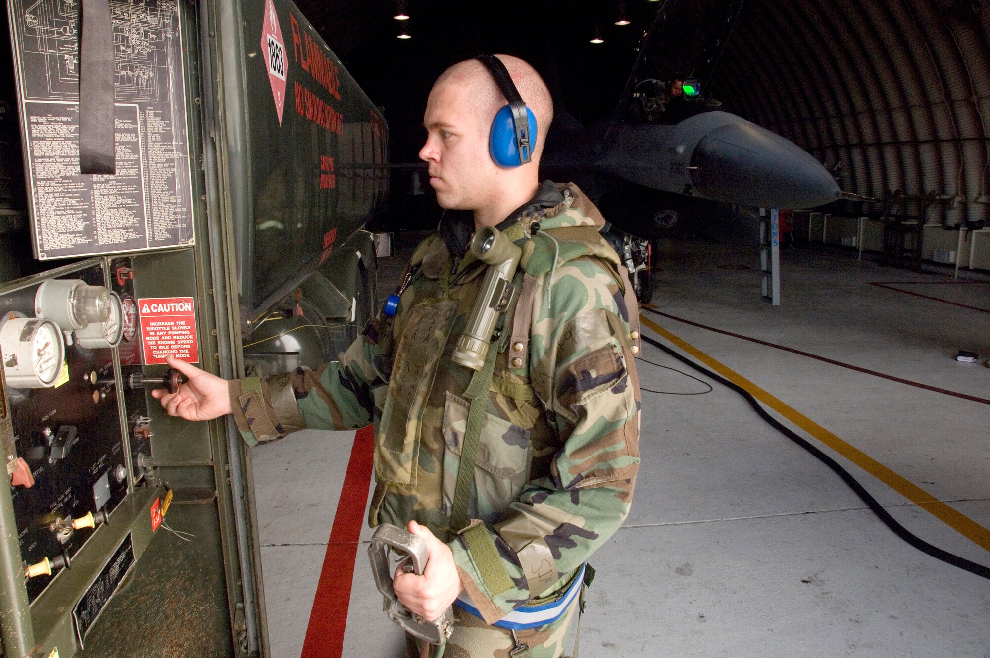 KUNSAN AIR BASE, South Korea --  Senior Airman Ben Johnson monitors fuel transfer during aircraft refueling operations Nov. 7 here.  Airman Johnson is a fuels distribution driver with the 8th Logistics Readiness Squadron who is participating in a Peninsula Operational Readiness Exercise.  The PENORE is conducted to ensure members of the Wolf Pack remain ready to execute its mission of “Defend the Base, Accept Follow on Forces and Take the Fight North.”  (U.S. Air Force Photo/Master Sgt.Jack Braden)