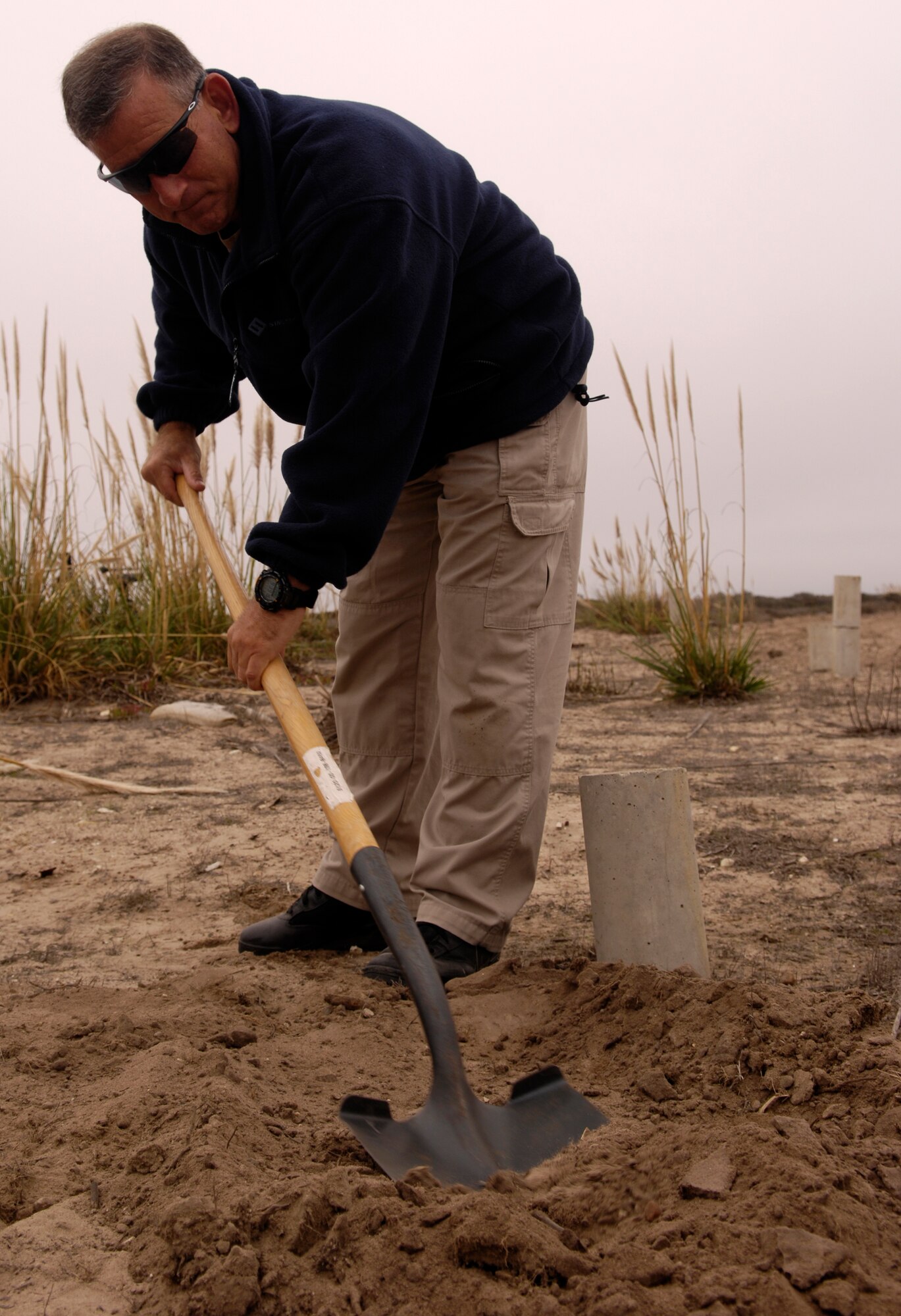 VANDENBERG AIR FORCE BASE, Calif. -- Ron Capra, with the Los Angeles Police Department Bomb Squad, conceals a secondary explosive device with dirt prior the detonation of 500 pounds of explosives used to demolish an ambulance during Federal Bureau of Investigations post-blast investigator training on Nov. 6. Federal, state and local law enforcement officers involved in bomb crime-scene investigations participate in this one-week course which places an emphasis on the identification and collection of fragmented and mutilated bomb components. (U.S. Air Force photo/Airman 1st Class Christian Thomas)
