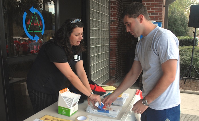Regina Creech, Health and Wellness Center element chief, speaks with an Airman about tobacco cessation before the Wingman Day Fun Run Nov. 2. (U.S. Air Force photo/Staff Sgt. Jennifer Arredondo)