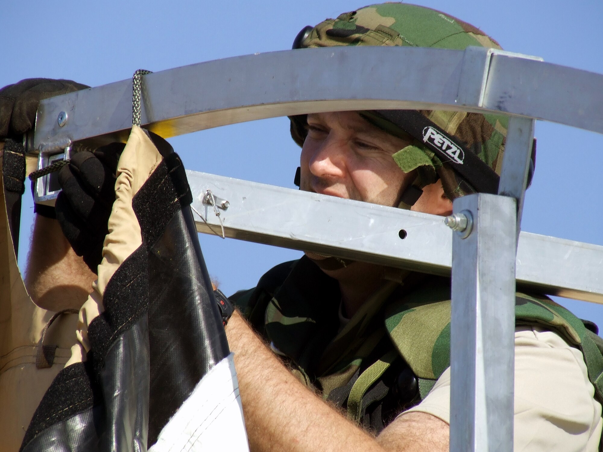 An Airman from the 818th Contingency Response Group, McGuire Air Force Base, N.J., works on building a tent for Air Force Exercise Eagle Flag 08-1 at Naval Air Engineering Station Lakehurst, N.J., Oct. 20.  The exercise, coordinated by the U.S. Air Force Expeditionary Center's 421st Combat Training Squadron, tests and trains more than 400 Airmen in expeditionary combat support career fields during six exercises every year.  The CRG unit is the first unit in the field during every exercise.  (U.S. Air Force Photo/Tech. Sgt. Scott T. Sturkol)