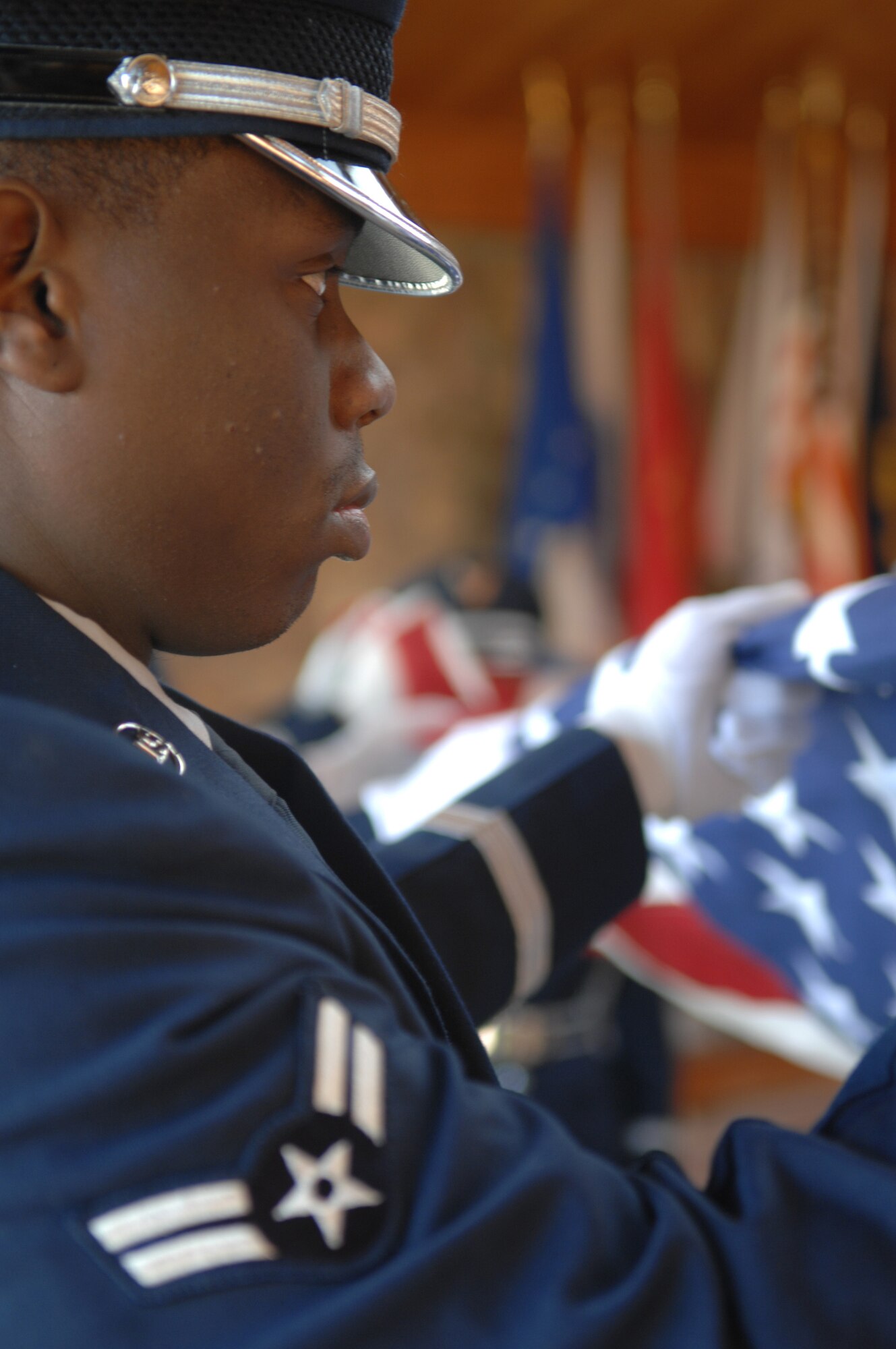 Airman First Class DCoridrion Hicks, 28th Operations Group, participates in the flag folding portion of a retiree funeral at the Black Hills National Cemetery Nov.1.  This funeral detail is the first seven-person funeral to be performed by the 28th Bomb Wing Honor Guard. 
(U.S. Air Force photo/Airman First Class Anthony Sanchelli)