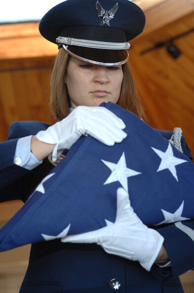 Senior Airman Kimberly Moore Limrick, 28th Bomb Wing Public Affairs, completes the flag folding portion of a retiree funeral at Black Hills National Cemetery Nov. 1.  This funeral detail is the first seven-person funeral to be performed by the 28th Bomb Wing Honor Guard. 
(U.S. Air Force photo/Airman First Class Anthony Sanchelli)