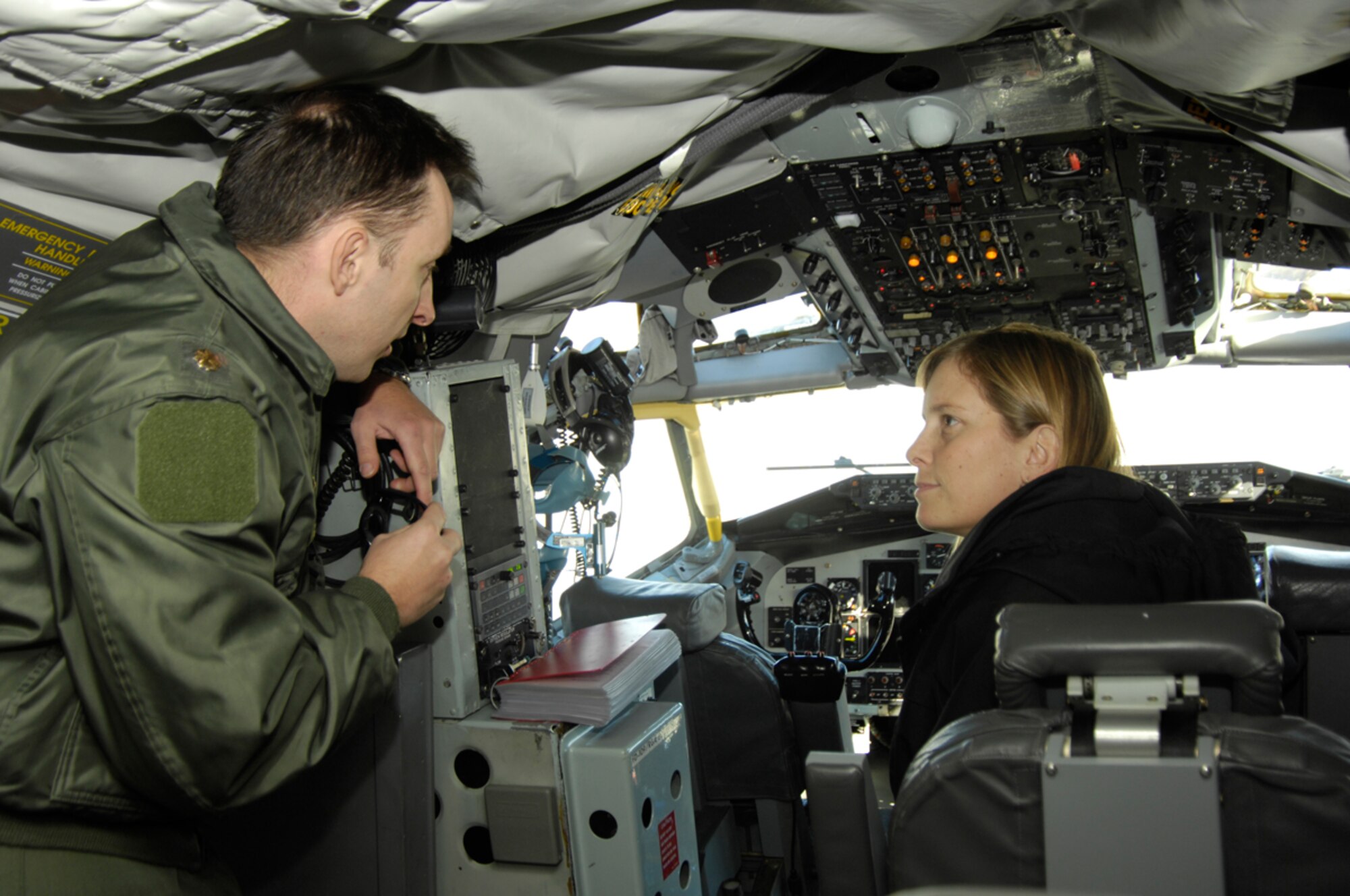 HANSCOM AFB, Mass. – Maj. Scott Kulka, pilot of the Speckled Trout, a modified KC-135R, shows Amanda Gustafson, a Raytheon employee, the cockpit of the aircraft during a visit to Hanscom on Nov. 7. The Speckled Trout is the official nickname given to the modified aircraft. The aircraft is fully equipped with an array of radio equipment, data links and cryptographic sets. It also serves as a test bed for proposed command and control systems. The 412th Flight Test Squadron at Edwards Air Force Base, Calif., operates the Speckled Trout and manages its test mission. (U.S. Air Force photo by Linda LaBonte Britt)

