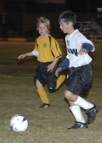 James French,11, a member of the youth soccer team for the Naval Weapons Station, kicks the ball on the field at Charleston AFB Monday. (U.S. Air Force photo/Airman 1st Class Katie Gieratz)