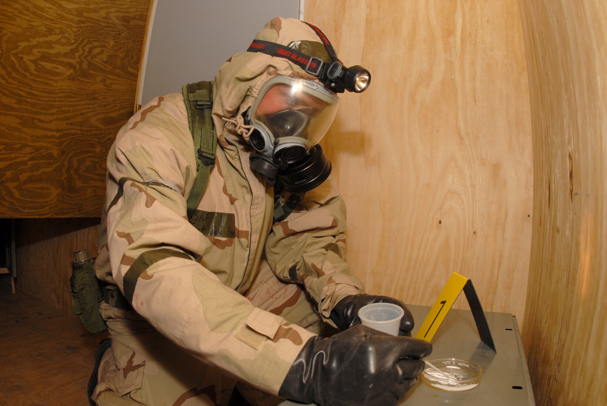 Tech. Sgt. Joseph D. Fluge, of the 119th Civil Engineer Squadron, takes a sample of an unknown powder during a training exercise at the Regional Training Site, Fargo, N.D., May 23. (U.S. Air Force photo by Senior Master Sgt. David H. Lipp)
