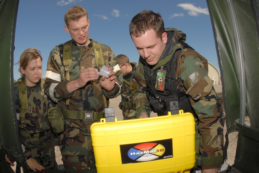From left to right, Staff Sgt. Laura Radliff and Senior Airman Adam Logue, both of the 183rd Civil Engineer Squadron, along with Staff Sgt. Mathew Lasek, of the 138th Civil Engineer Squadron, use a HazMatID chemical substance identifying computer to test for evidence of weapons of mass destruction during a training exercise at the Air National Guard Regional Training Site, Fargo, N.D., May 23. (U.S. Air Force photo by Senior Master Sgt. David H. Lipp)