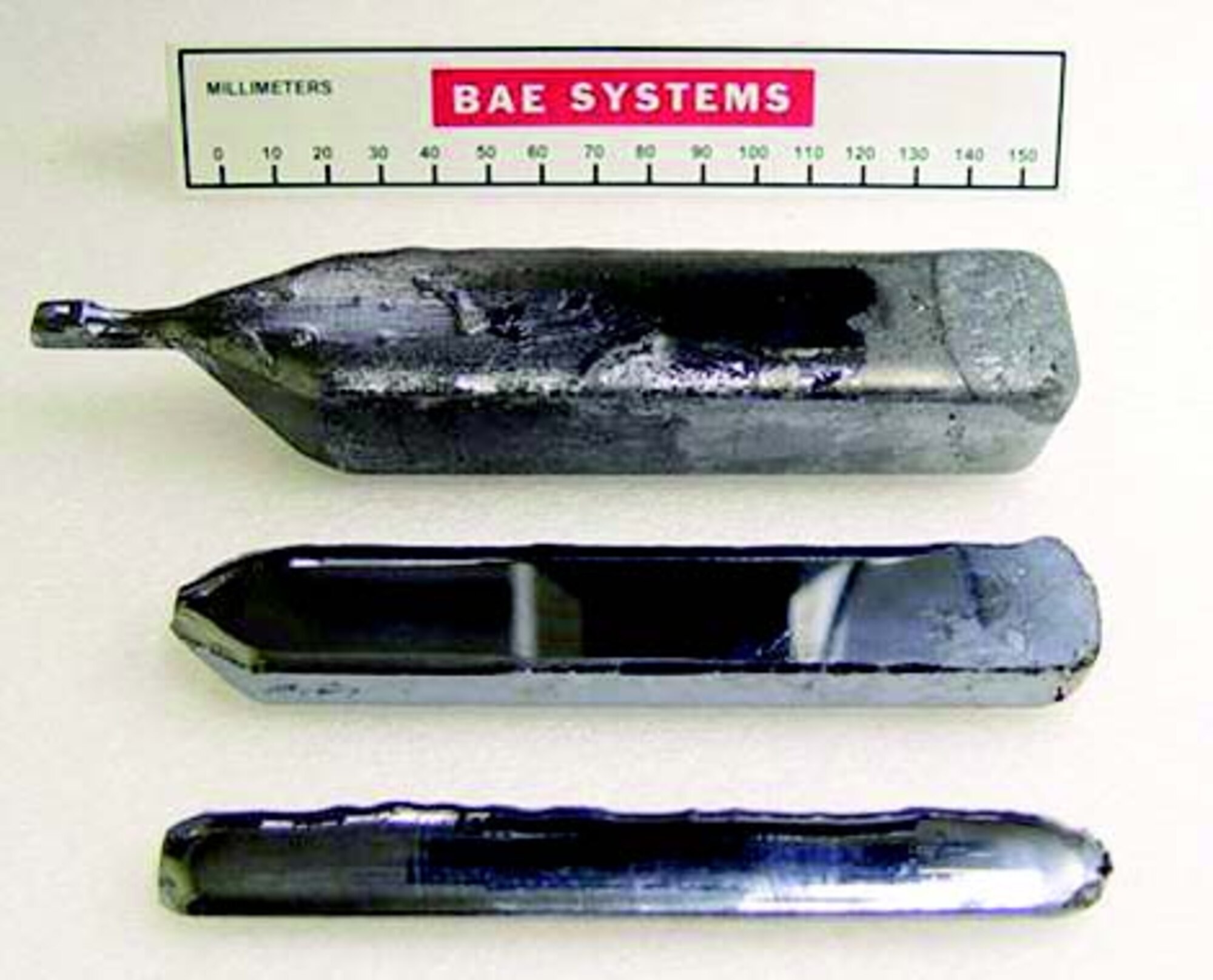 Pictured top to bottom are advanced materials in development, the boule for AFRL’s laser part, and a standard-sized boule.