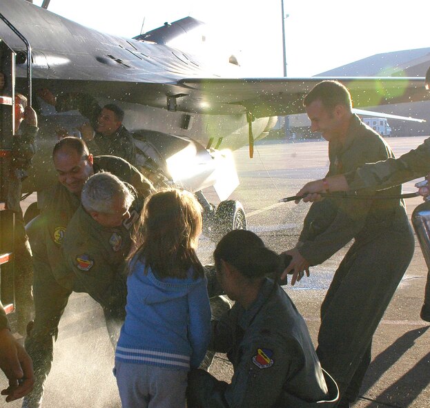 Col. Todd Harmer, 388th Fighter Wing vice commander, is held down and sprayed after his final flight with the wing Nov. 6. Colonel Harmer is scheduled to be the commander of the 33rd FW at Eglin Air Force Base in January.