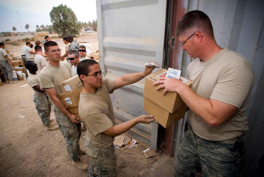 Airmen from Material Recovery Team III with the 732nd Expeditionary Logistics Readiness Squadron and Soldiers from 1st Battalion 9th Infantry Regiment unload a container express Oct. 19 at Camp Corregidor, Iraq. Serviceable assets recovered from the container express are inventoried and redistributed to Army units throughout Iraq. Airmen of various career fields volunteer to augment the Army in nontraditional "in-lieu-of" taskings for up to a year. (U.S. Air Force photo/Master Sgt. John Nimmo Sr.) 