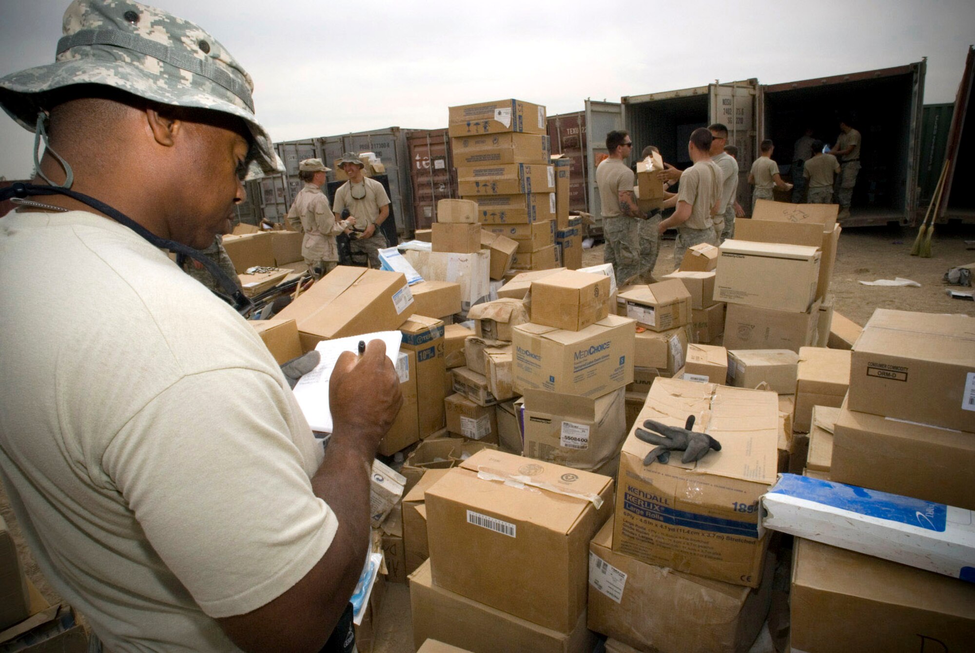 Master Sgt. Kevin Jackson records the product name, quantity and national stock number of the items unloaded from container express Oct. 19 at Camp Corregidor, Iraq. Serviceable assets recovered from the container express are inventoried and redistributed to Army units throughout Iraq. Airmen of various career fields volunteer to augment the Army in nontraditional "in-lieu-of" taskings for up to a year. Sergeant Johnson, from Material Recovery Team III with the 732nd Expeditionary Logistics Readiness Squadron, is deployed from Barksdale Air Force Base, La. (U.S. Air Force photo/Master Sgt. John Nimmo Sr.) 
