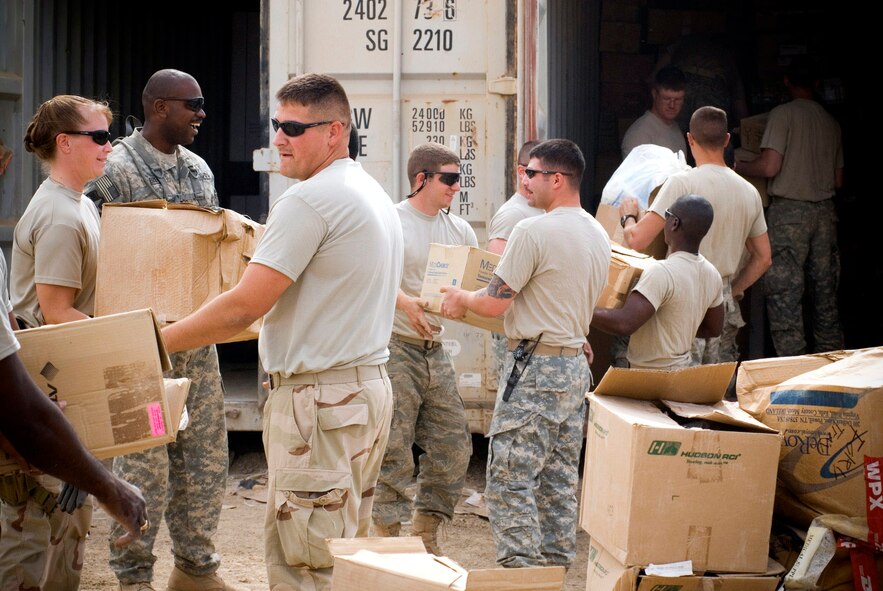 Airmen from Material Recovery Team III with the 732nd Expeditionary Logistics Readiness Squadron and Soldiers from 1st Battalion 9th Infantry Regiment unload a container express Oct. 19 at Camp Corregidor, Iraq. Serviceable assets recovered from the container express are inventoried and redistributed to Army units throughout Iraq. Airmen of various career fields volunteer to augment the Army in nontraditional "in-lieu-of" taskings for up to a year. (U.S. Air Force photo/Master Sgt. John Nimmo Sr.) 