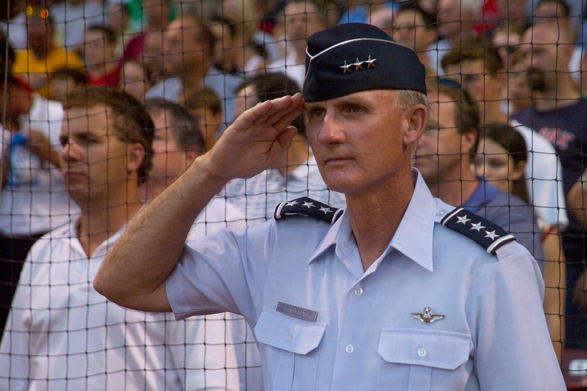 HANSCOM AFB, Mass. -- Lt. Gen. Chuck Johnson salutes during the playing of the National Anthem at Fenway Park in Boston. The general threw the first pitch during the game. (U.S. Air Force photo by Jan Abate)