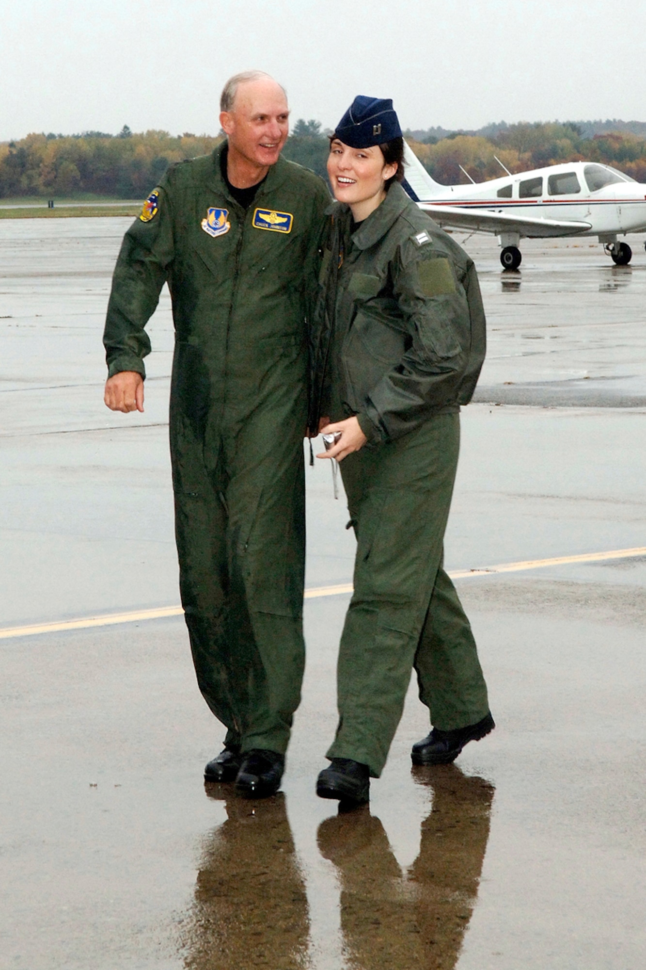 HANSCOM AFB, Mass. -- Lt. Gen. Chuck Johnson, who retired from the Air Force Nov. 7 after a 35 year career, walks with his daughter, Dr. (Capt.) Andrea Johnson, following his ‘final flight,’ aboard a C-17 that took off from and landed at Hanscom Nov. 6. Captain Johnson, a resident at Bethesda Naval Medical Center in Washington, D.C., flew aboard the C-17 with her father. (U.S. Air Force photo by Jan Abate)

