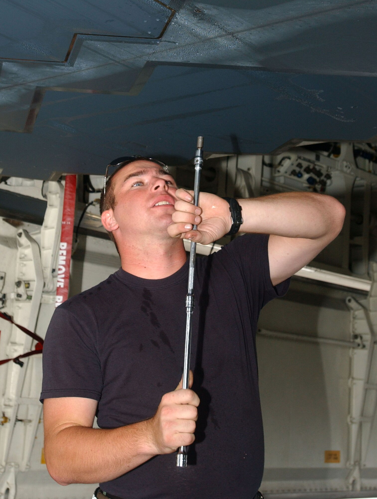 Senior Airman Patrick Bost prepares a B-2 Spirit bomber Oct. 24 for a combat training sortie at Andersen Air Force Base, Guam. Airman Bost is a maintainer deployed from Whiteman AFB, Mo., as part of a small contingent of specialists that work on the stealth airframe. (U.S. Air Force photo/Senior Airman Brian Kimball)