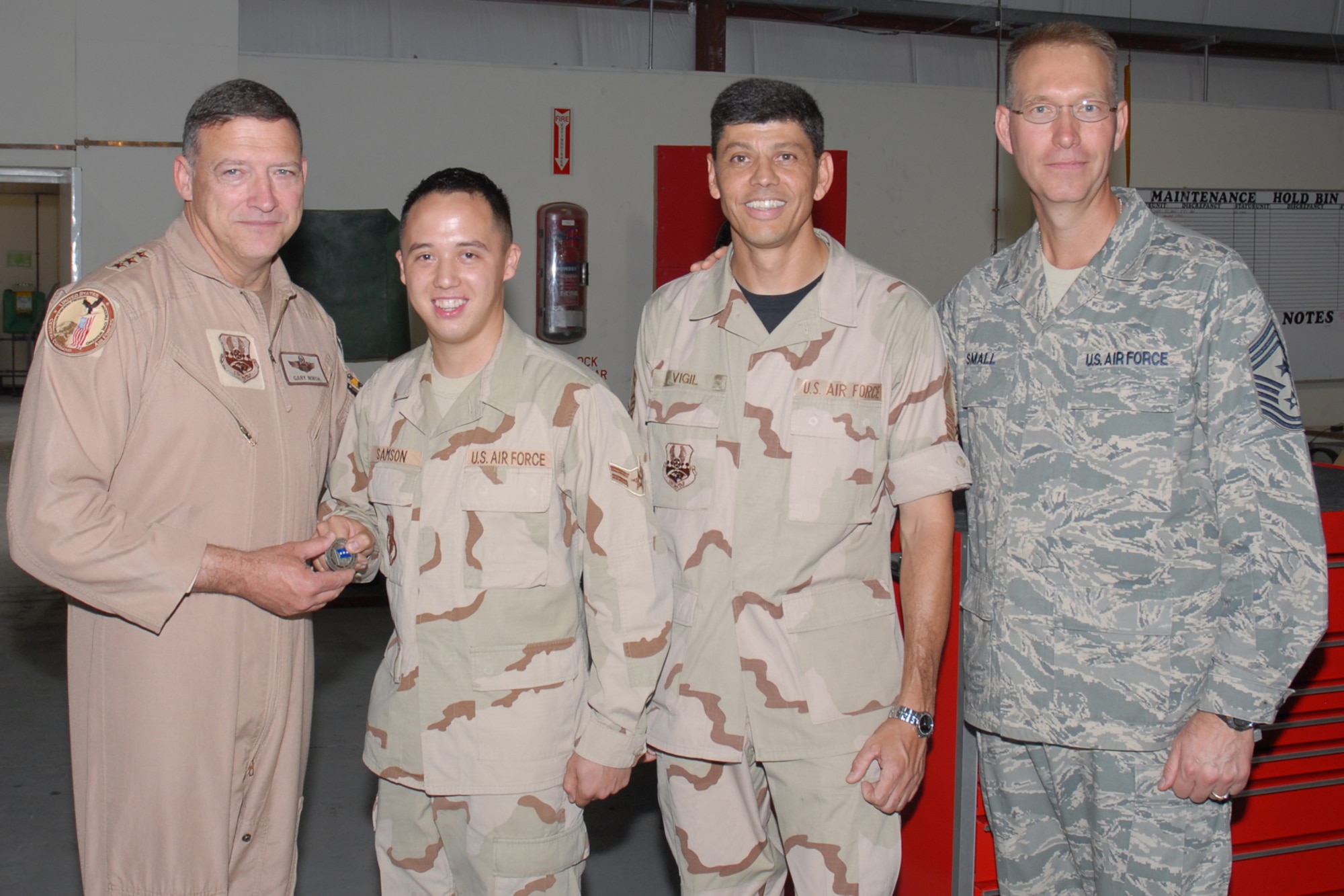Lieutenant Gen. Gary L. North, commander, 9th Air Force and U.S. Central Command Air Force, recognizes Airman 1st Class Kennith Samson, 379th Expeditionary Maintenance Squadron AGE flight deployed from Dyess AFB, Texas, for superior performance in Southwest Asia Oct. 27. General North travels to many forward-operating locations to spend time with deployed Airmen. (U.S. Air Force photo by Staff Sergeant Douglas C. Olsen)
