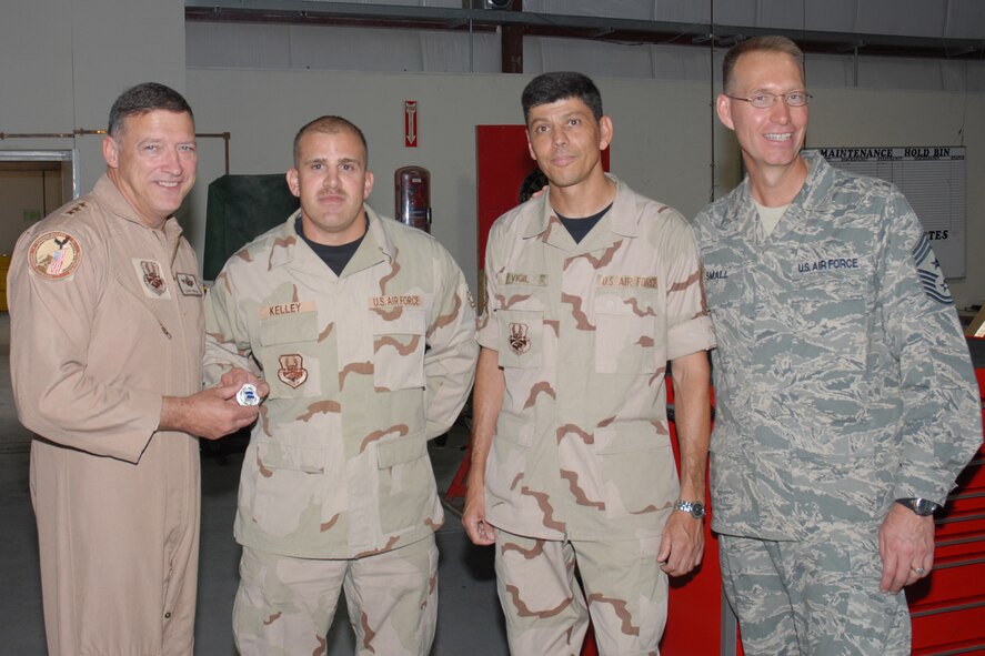 Lieutenant Gen. Gary L. North, commander, 9th Air Force and U.S. Central Command Air Force, recognizes Tech. Sgt. Michael J. Kelley, 379th Expeditionary Maintenance Squadron AGE flight deployed from Dyess AFB, Texas, for superior performance during a visit to Southwest Asia Oct. 27. General North travels to many forward-operating locations to spend time with deployed Airmen. (U.S. Air Force photo by Staff Sergeant Douglas C. Olsen)
