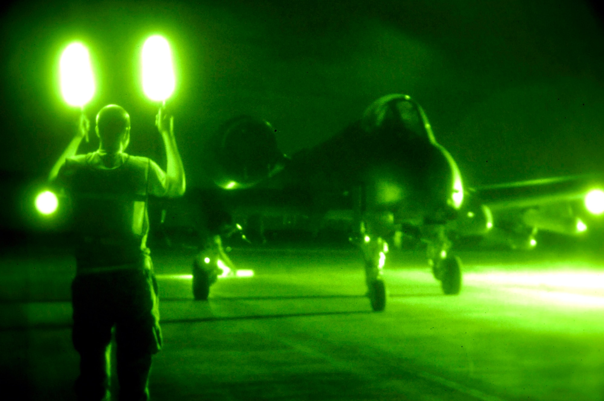 Senior Airman Daniel Young marshals in an A-10 Thunderbolt II for munitions disarming after an Oct. 28 mission at Al Asad Air Base, Iraq. The A-10C's are assigned to the 104th Expeditionary Fighter Squadron, which is made up primarily of members from the 175th Maryland Air National Guard. Airman Young is a Maryland Air National Guard crew chief. The 104th EFS is the first unit to use the C-model A-10 in a combat zone. Its upgrades have made air power more efficient and have streamlined the close-air-support mission. (U.S. Air Force photo/Staff Sgt Angelique Perez)
