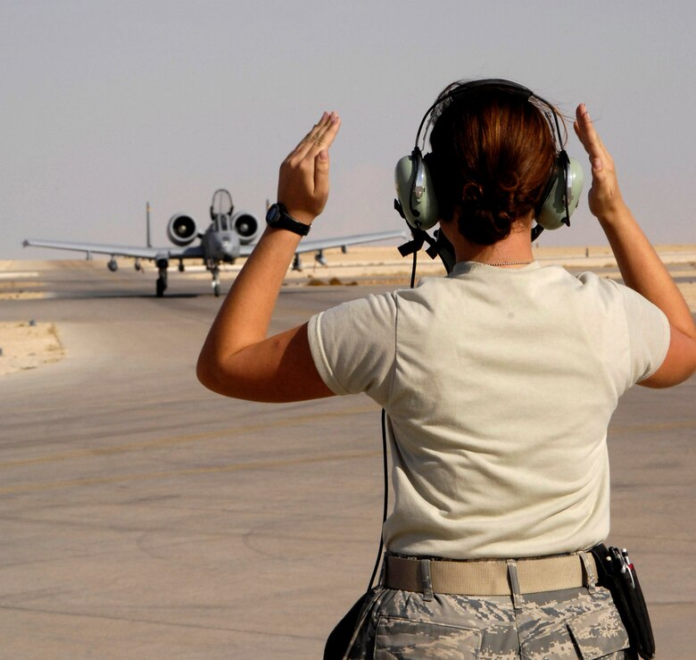 Senior Airman Natalie Jones marshals in an A-10 Thunderbolt II after an Oct. 27 mission at Al Asad Air Base, Iraq. The A-10C's are assigned to the 104th Expeditionary Fighter Squadron made up primarily of the 175th Maryland Air National Guard. Airman Jones is a Maryland Air National Guard crew chief. The 104th EFS is the first unit to use the C-model A-10 in a combat zone. Its upgrades have made air power more efficient and have streamlined the close-air-support mission. (U.S. Air Force photo/Staff Sgt Angelique Perez)