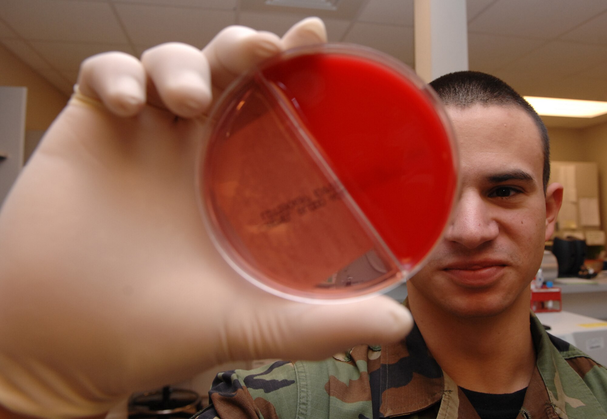 Senior Airman James Burley, a lab technician with the 1st Special Operations Medical Operations Squadron, examines an incubated culture sample for growth Nov. 6. The lab is one of several sections assigned to the 1st SOMDOS. (U.S. Air Force photo by Senior Airman Julianne Showalter) 
