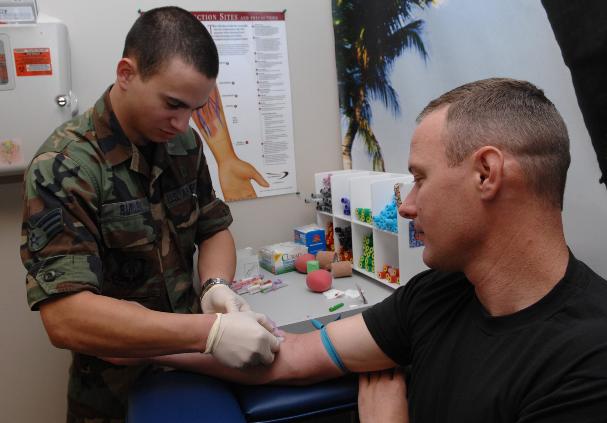 Senior Airman James Burley, a lab technician with the 1st Special Operations Medical Operations Squadron, draws blood from Staff Sgt. Daniel Roberson, 1st Special Operations Logistics Readiness Squadron, for a bone marrow compatibility test Nov. 6. The lab is one of several sections assigned to the 1st SOMDOS. (U.S. Air Force photo by Senior Airman Julianne Showalter)