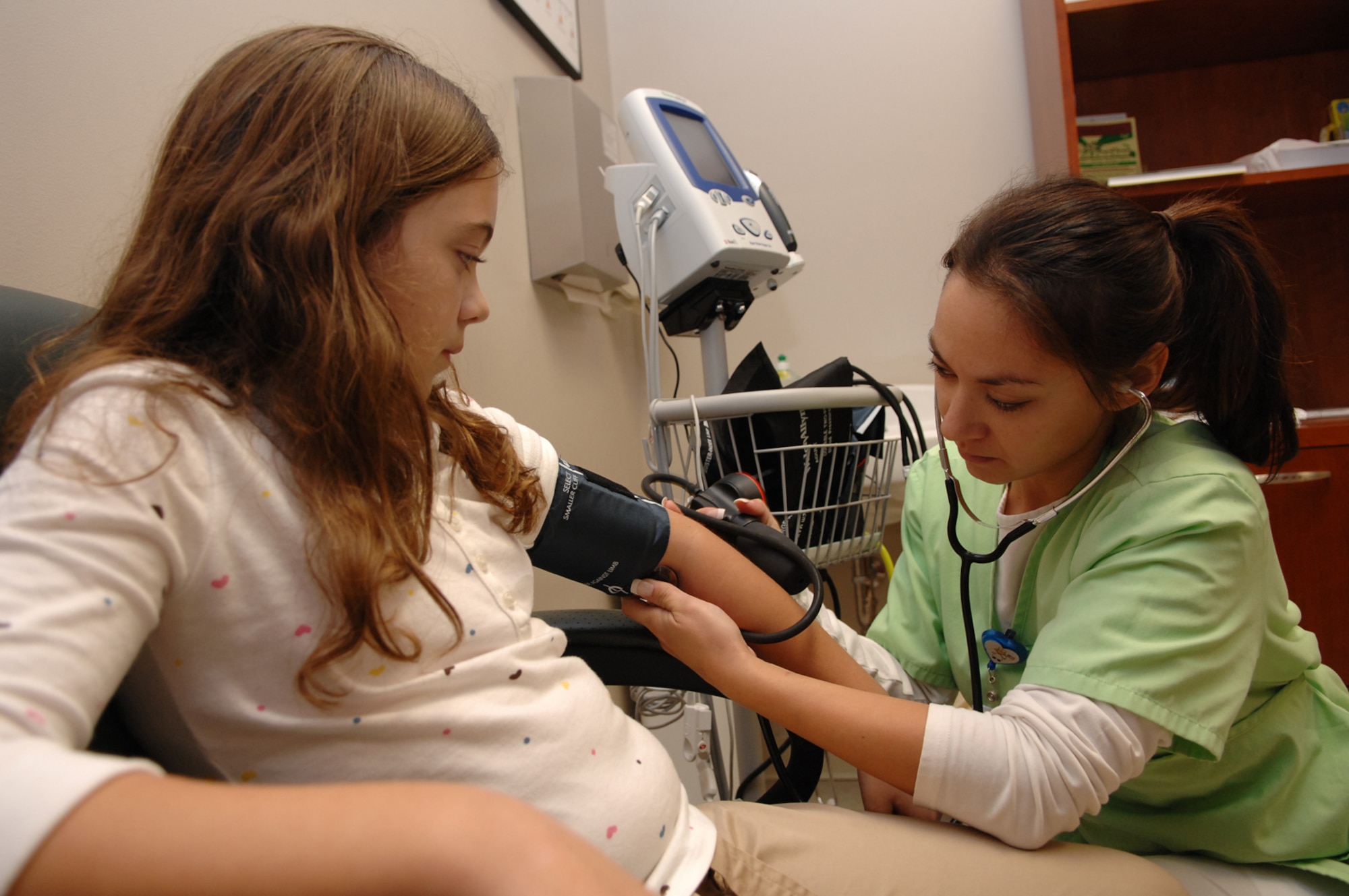 Lisa Beasley, 1st Special Operations Medical Group, takes Christina Oldnettle's blood pressure and vitals in the pediactrics clinic at Hurlburt Field Nov. 6. Pediatrics is one of several sections assigned to the 1st Special Operations Medical Operations Squadron. (U.S. Air Force photo by Senior Airman Julianne Showalter) 