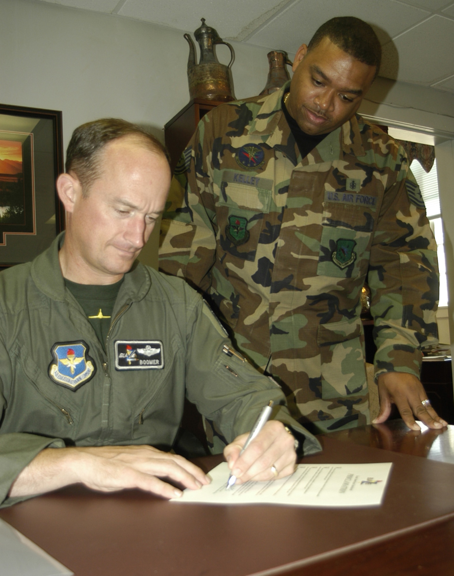 Col. Dave Gerber, 14th Flying Training Wing commander, signs a proclamation Friday for the Great American Smokeout while Tech. Sgt. David Kelley, 14th Medical Operations Squadron, looks on. The Health and Wellness Center is asking smokers to stop smoking Nov. 15,  along with other smokers across the U.S. (U.S. Air Force photo by Senior Airman John Parie)
