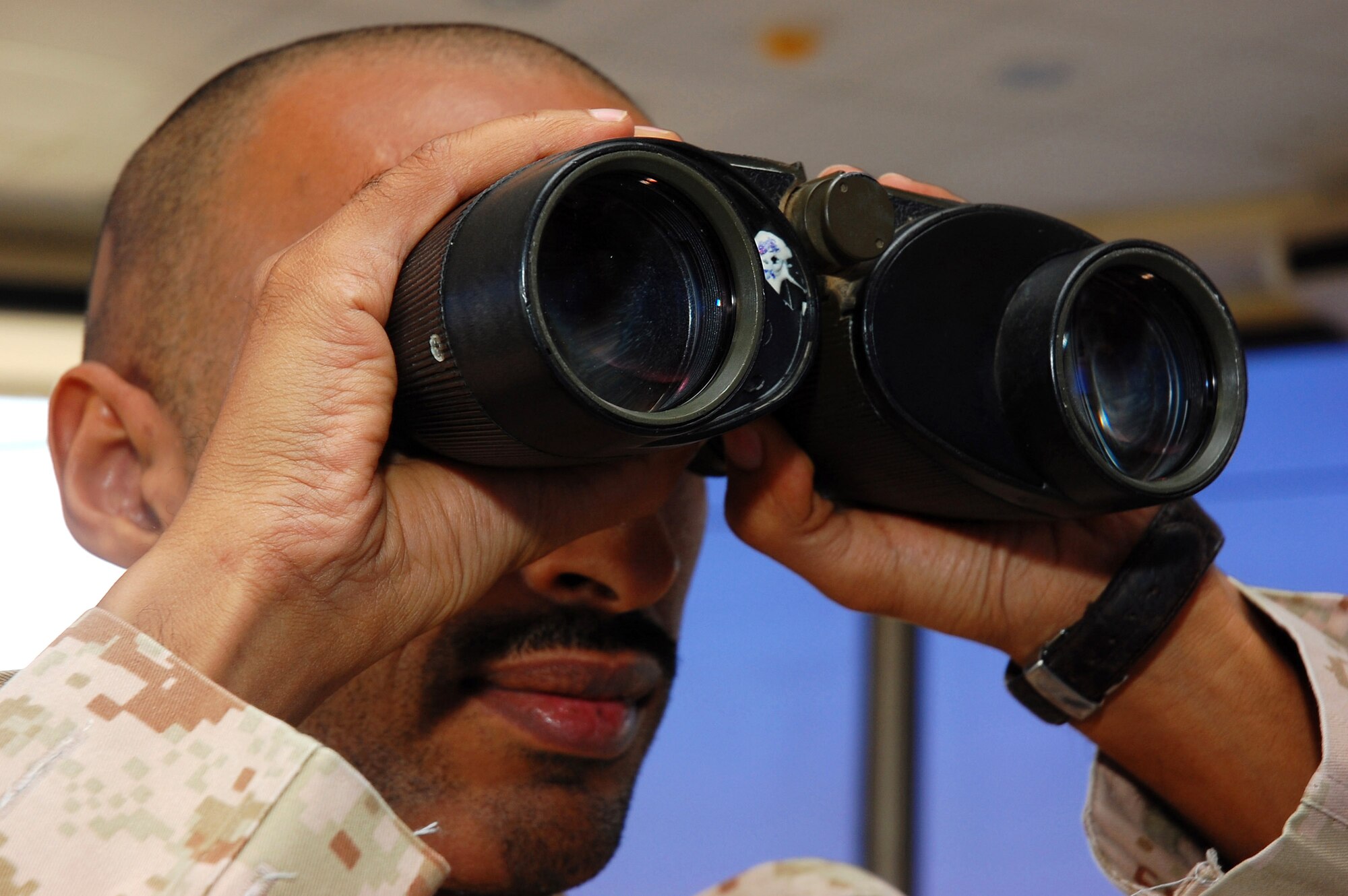 Sgt. Abdullah Al. Ajmi scans the horizon for an inbound aircraft Nov. 2 in Southwest Asia. Sergeant Ajmi, is a host nation air traffic controller, is responsible for the safe and expeditious flow of air traffic at the base. (U.S. Air Force photo/Staff Sgt. Tia Schroeder) 
