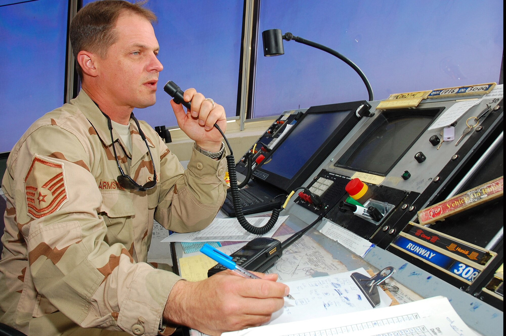 Master Sgt. James Armstrong communicates with an inbound aircraft requesting landing clearance Nov. 2 in Southwest Asia. Sergeant Armstrong, the 386th Operations Group air traffic controller NCO in charge, is deployed from Royal Air Force Mildenhall, England. (U.S. Air Force photo/Staff Sgt. Tia Schroeder) 
