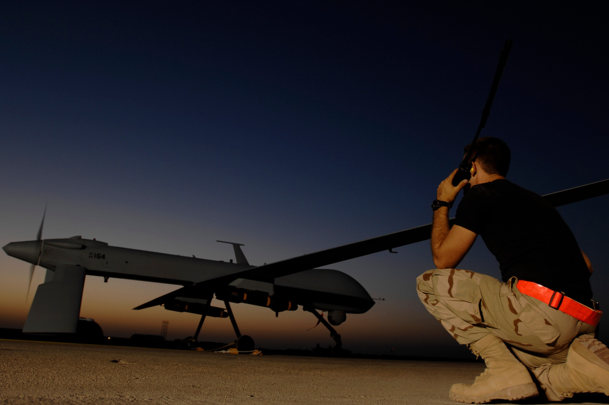 Airman 1st Class Justin Cole communicates with the pilot of an MQ-1 Predator Unmanned Aerial Vehicle in preparation for a night mission Nov. 5 at Ali Base, Iraq. The Predators are now fully operational and have begun 24-hour operations. Airman Cole is deployed from Creech Air Force Base, Nev. (U.S. Air Force photo/Airman 1st Class Jonathan Snyder)