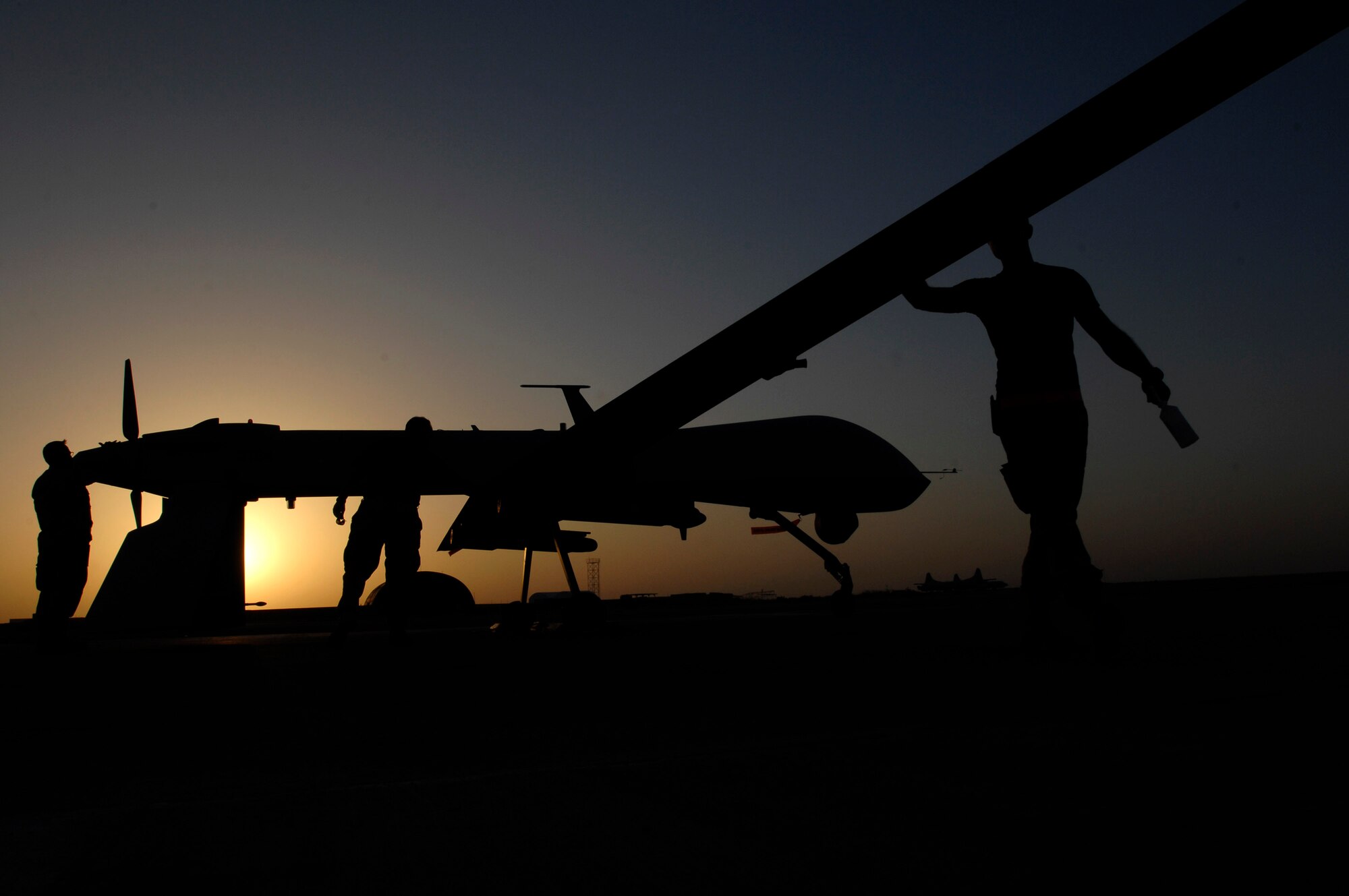 Airman 1st Class Justin Cole, Tech. Sgt. Marcus Cottengim and Chief Master Sgt. Roy Cupper conduct a pre-flight inspection on an MQ-1 Predator Unmanned Aerial Vehicle Nov. 5 at Ali Base, Iraq. The Predators are now fully operational and have begun 24-hour operations. The Airmen are deployed from Creech Air Force Base, Nev. (U.S. Air Force photo/Airman 1st Class Jonathan Snyder) 