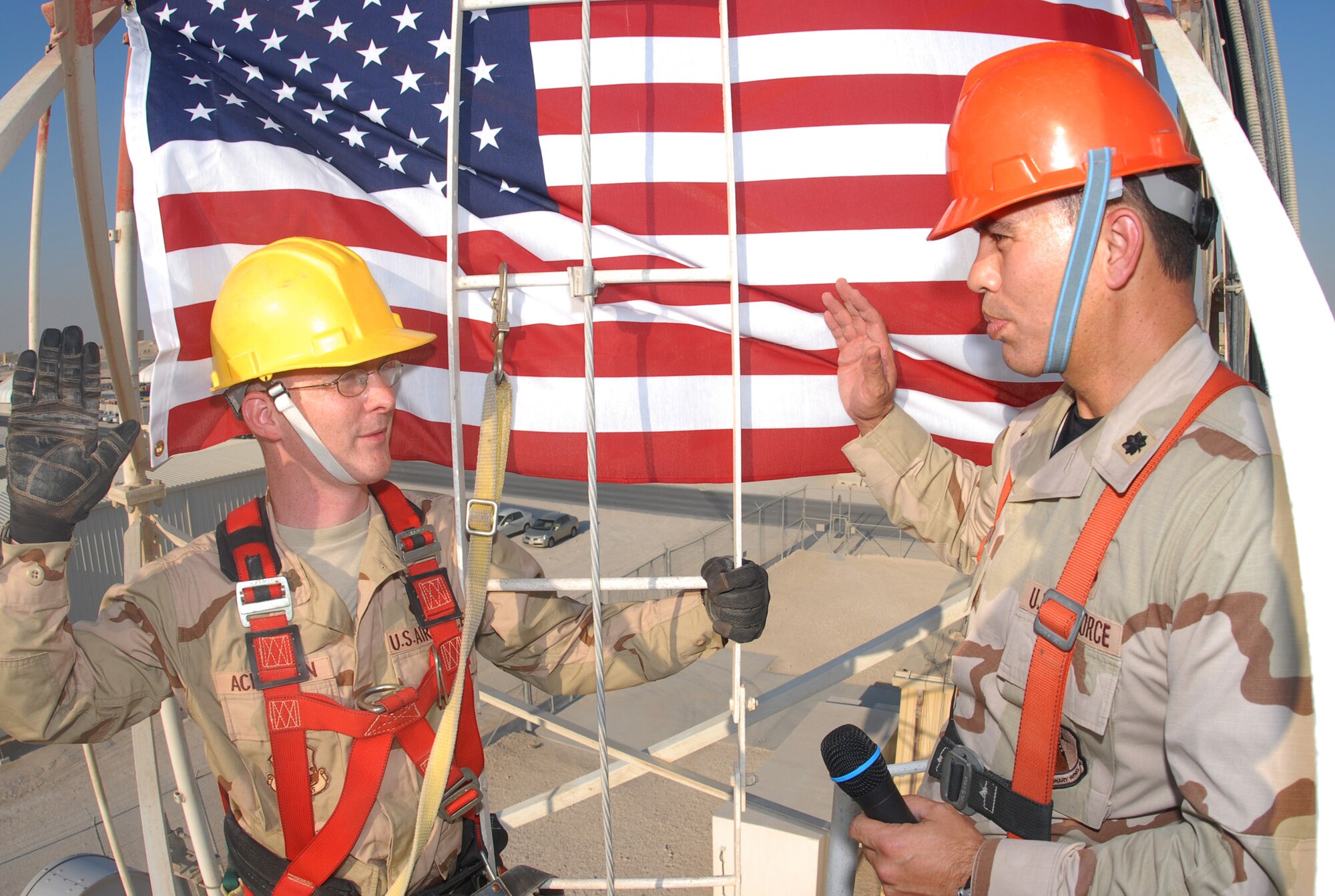 SOUTHWEST ASIA - Capt. Alexander Ackerman, 379th Expeditionary Communications Squadron, Recites his officer’s oath as he is promoted to the rank of Major. His promotion ceremony was held 50 feet off the ground on a radio antenna tower platform Oct. 31. Lt. Col. Mike Benson, 379th Expeditionary Communications Squadron commander administered the oath.(U.S. Air Force photo\Staff Sgt. Douglas Olsen)
