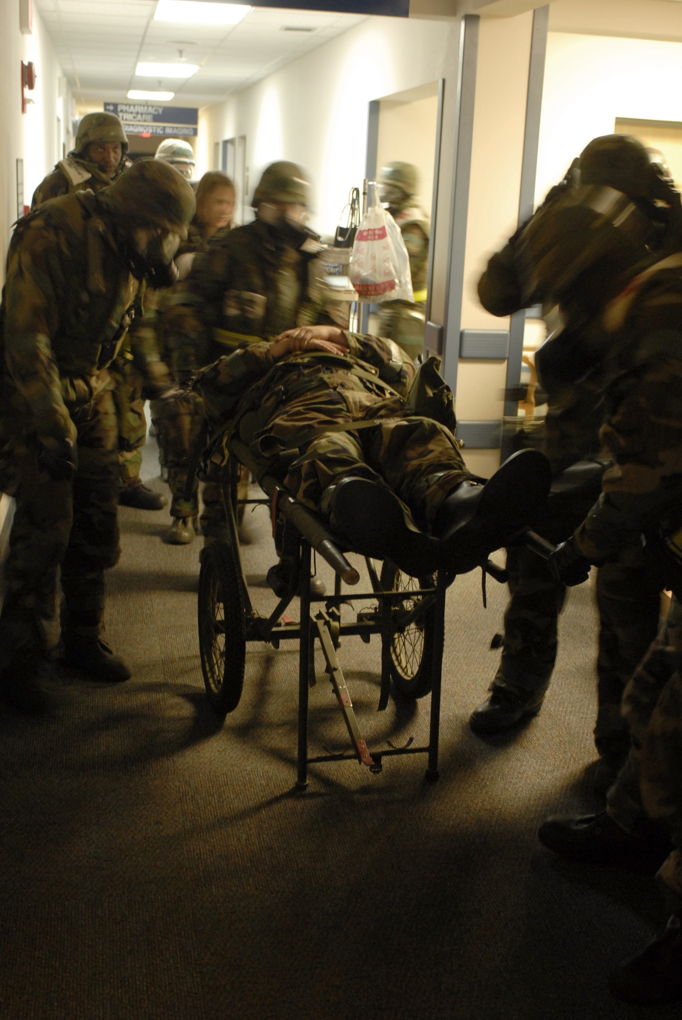 KUNSAN AIR BASE, South Korea -- Personnel from the 8th Medical Operations Squadron rush a cardiac arrest victim in a simulated exercise during the Peninsula Operational Readiness Exercise here Nov. 7. The exercise is conducted to ensure members of the Wolf Pack remain ready to execute its mission of “Defending the Base, Accepting Follow on Forces and Taking the Fight North.”  (U.S. Air Force photo/Senior Airman Steven R. Doty)