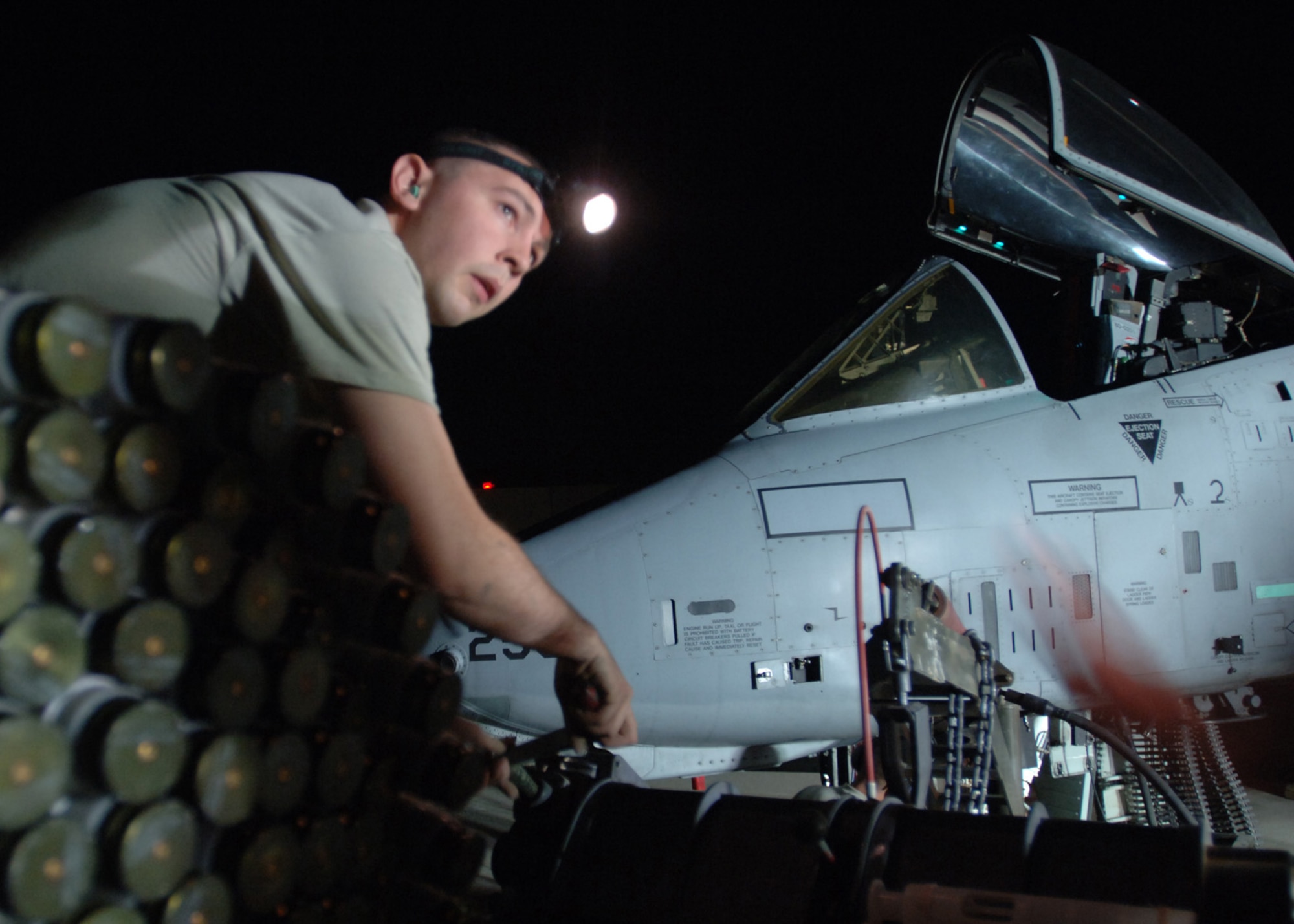 AL ASAD AIR BASE, Iraq -- Senior Airman Michael Knecht, 438th Air Expeditionary Group weapons loader, helps load 30 mm rounds for an A-10C Thunderbolt II’s Gatling gun before a night-combat operation here. Airman Knecht is deployed from the 175th Wing, Maryland Air National Guard, Baltimore. (U.S. Air Force photo/Tech. Sgt. D. Clare)