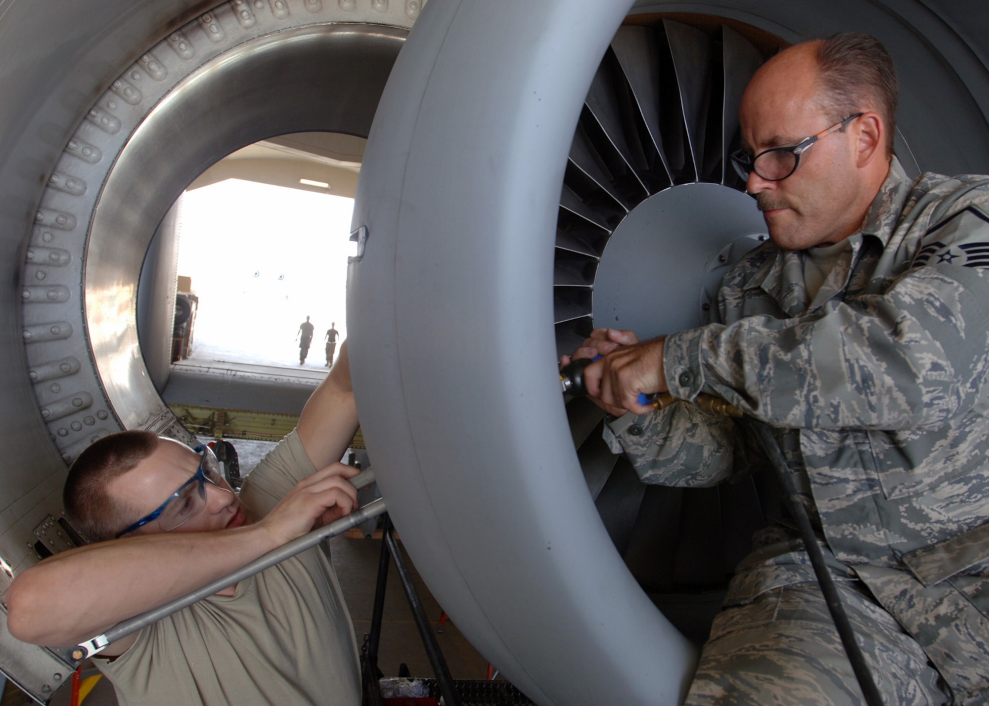 AL ASAD AIR BASE, Iraq -- Staff Sgt. Jonathan Pollack, 438th Air Expeditionary Group structural maintenance technician, (left) and Master Sgt. Anthony Bahur, structural maintenance supervisor, perform a structural repair on an A-10C Thunderbolt II's engine inlet here. The 438th AEG’s newly upgraded A-10C Thunderbolt IIs are the first to fly in combat. Sergeants Pollack and Bahur are deployed from the 175th Wing, Maryland Air National Guard, Baltimore. (U.S. Air Force photo/Tech. Sgt. D. Clare)