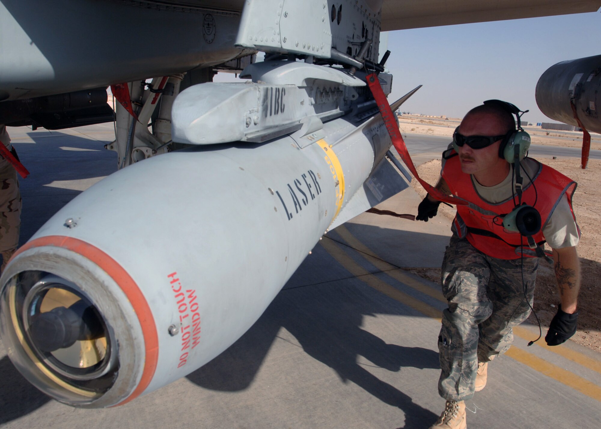 AL ASAD AIR BASE, Iraq -- Tech. Sgt. Frank Williams, 438th Air Expeditionary Group weapons loader, checks munitions on an A-10C Thunderbolt II here, pulling arming pins so pilots can employ weapons. The 438th AEG is the first unit to fly newly upgraded A-10C Thunderbolt IIs in combat. The improved aircraft’s precision engagement abilities allow it to more accurately strike enemy targets, reducing dangers to coalition forces and non-combatants. Sergeant Williams is deployed from the 175th Wing, Maryland Air National Guard, Baltimore. (U.S. Air Force photo/Tech. Sgt. D. Clare)