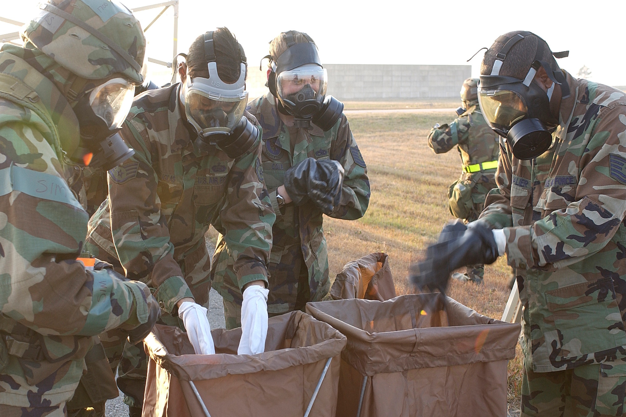 KUNSAN AIR BASE, South Korea--Members of the Wolf Pack dispose their contaminated gears during the Peninsula Operational Readiness Exercise here Nov. 7 here. The exercise is conducted to ensure members of the Wolf Pack remain ready to execute its mission of “Defending the Base, Accepting Follow on Forces and Taking the Fight North.” (U.S. Air Force photo/Senior Airman Giang Nguyen)

                               
