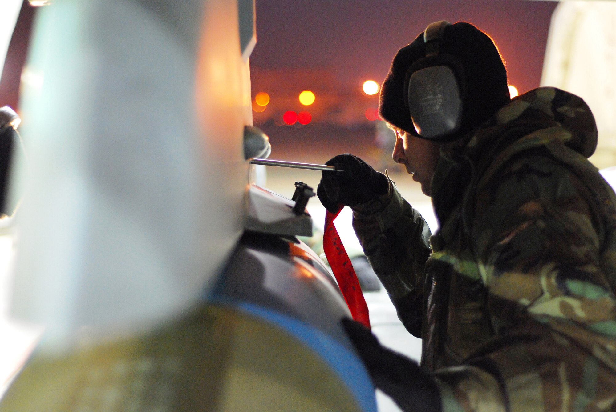 KUNSAN AIR BASE, South Korea -- Senior Airman Nicholas Canterbury, 8th Aircraft Maintenance Squadron weapons load crew member, installs a bomb rack safety pin on an inert MK-84, 20,000 pound general purpose bomb, during the Peninsula-wide Operational Readiness Exercise Nov. 07 here. The Peninsula wide ORE tests the ability of the 8th Fighter Wing to conduct its three-tier mission. (U.S. Air Force Photo/Chief Master Sgt. William McElligott)