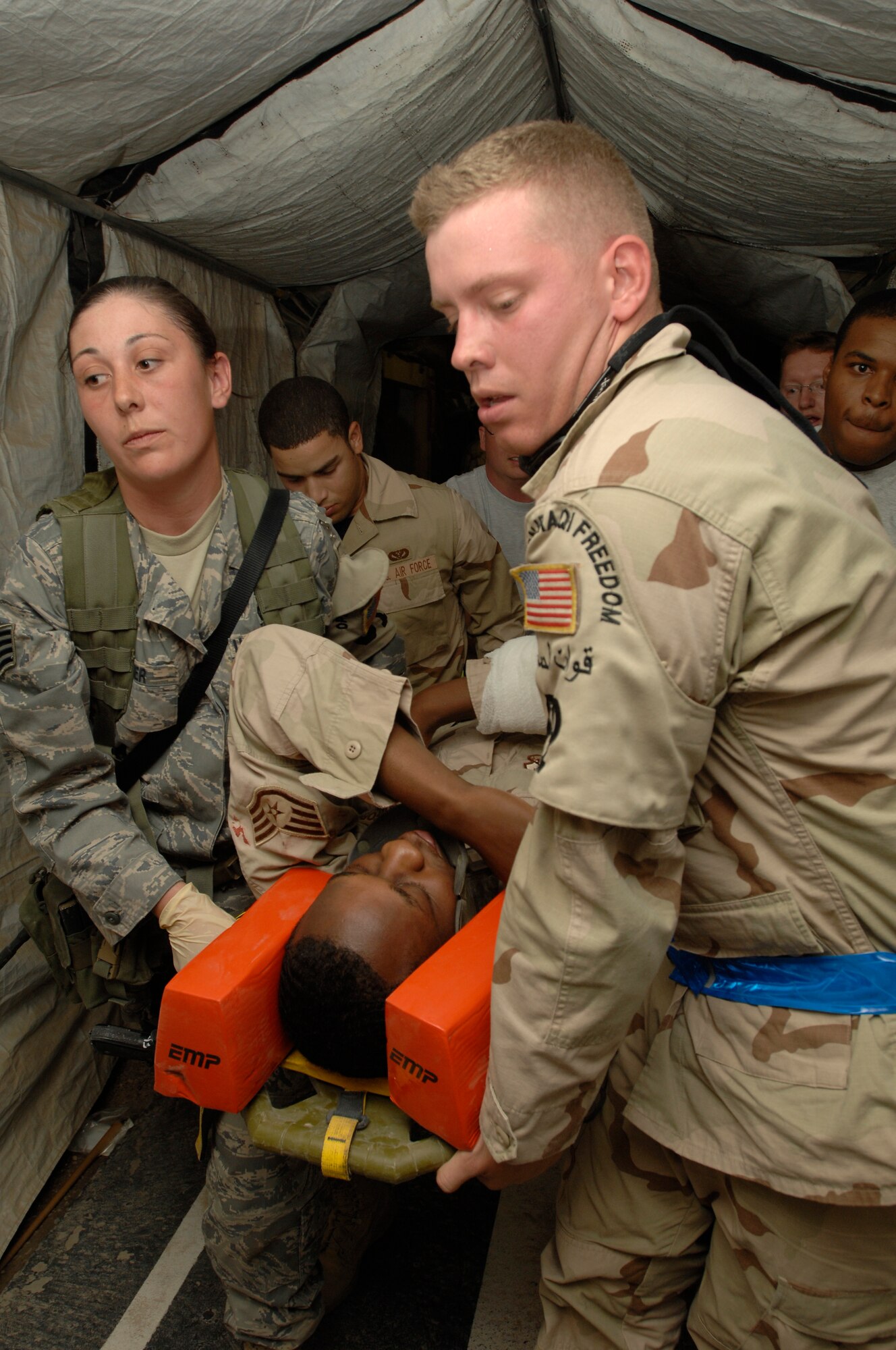 ALI AIR BASE, Iraq -- Staff Sgt. Jennifer Fisher helps transport a victim to an ambulance Nov. 1 during a major accident response exercise . This exercise is designed to test how Airmen will react and the response time of emergency teams to treat the victims and ultimately working together as a team. Sergeant Fisher is assigned to the 407th Expeditionary Security Forces Squadron and is deployed from Seymour-Johnson Air Force Base, N.C. (U.S. Air Force photo/Airman 1st Class Jonathan Snyder)