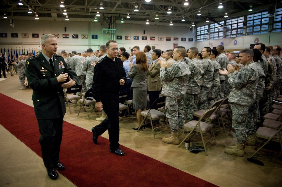 U.S. Navy Adm. Michael G. Mullen, chairman of the Joint Chiefs of Staff, and Gen. Burwell B. Bell, commander of U.S. Forces Korea, depart Collier Field House on Yongsan Army Garrison after a town hall meeting with U.S. troops stationed in the Republic of Korea, Nov. 7, 2007.