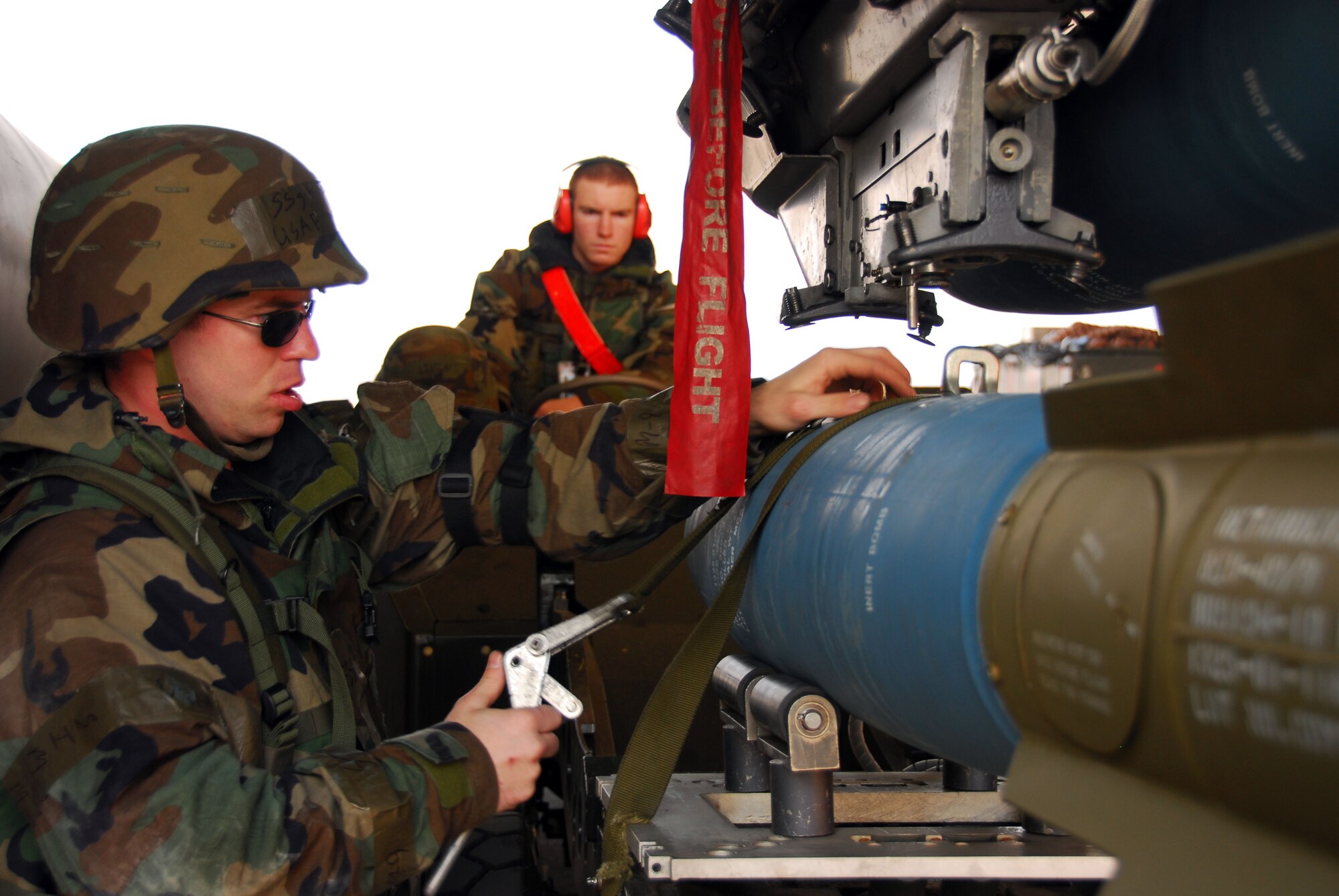 OSAN AIR BASE, Republic of Korea -- Staff Sgt Mikel Parrish and Airman 1st Class Patrick Ward both 51st Aircraft Maintenance Squadron weapons load crew member load the  BDU-50 (practice bomb) on a F-16. During a peninsula wide exercise on Osan AB, South Korea.  The exercise Beverly Bulldog 08-01 scenarios test Team Osan's ability to defend the base and conduct daily operations in a combat environment.  (U.S. Air Force Photo by Staff Sgt Ronnie Hill) (Released)  