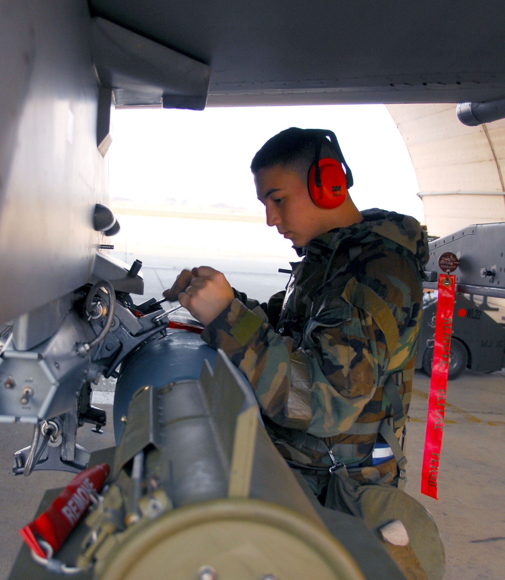 OSAN AIR BASE, Republic of Korea -- Airman 1st Class Patrick Ward, 51st Aircraft Maintenance Squadron weapons load crew member tighten down the BDU-50 (practice bomb) during a peninsula wide exercise on Osan AB, South Korea.  The exercise Beverly Bulldog 08-01 scenarios test Team Osan's ability to defend the base and conduct daily operations in a combat environment.  (U.S. Air Force Photo by Staff Sgt Ronnie Hill) (Released)
