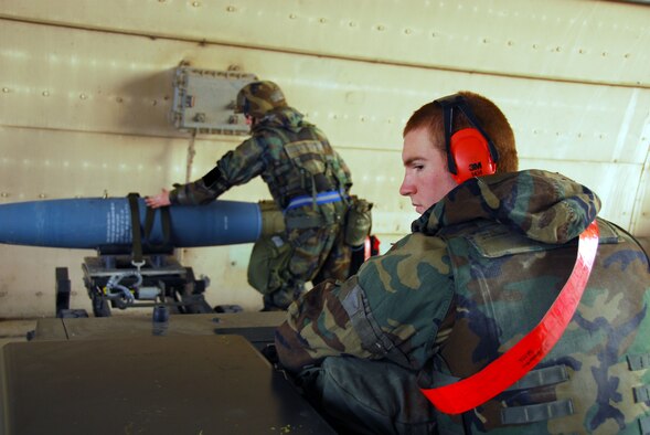 OSAN AIR BASE, Republic of Korea -- Airman 1st Class Steven Chamberlin, 51st Aircraft Maintenance Squadron weapons load crew member operates the weapons load jammer while Staff Sgt Mikel Parrish, 51st Aircraft Maintenance Squadron weapons load crew member, secures the BDU-50 (practice bomb) to the load jammer. During a peninsula wide exercise here. The exercise Beverly Bulldog 08-01 scenarios test Team Osan's ability to defend the base and conduct daily operations in a combat environment. (U.S. Air Force Photo by Staff Sgt Ronnie Hill) (Released) 